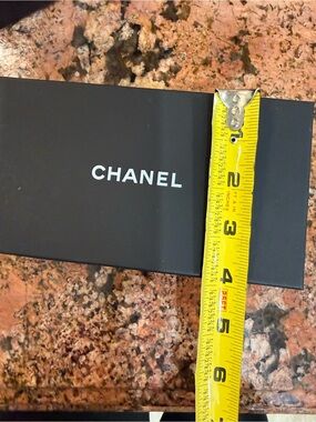 CHANEL Black Box with White Logo and Yellow Tape Accent